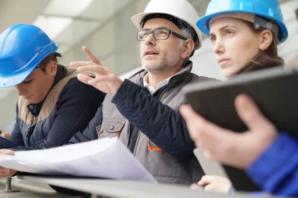 4 Workers Analyzing Construction
